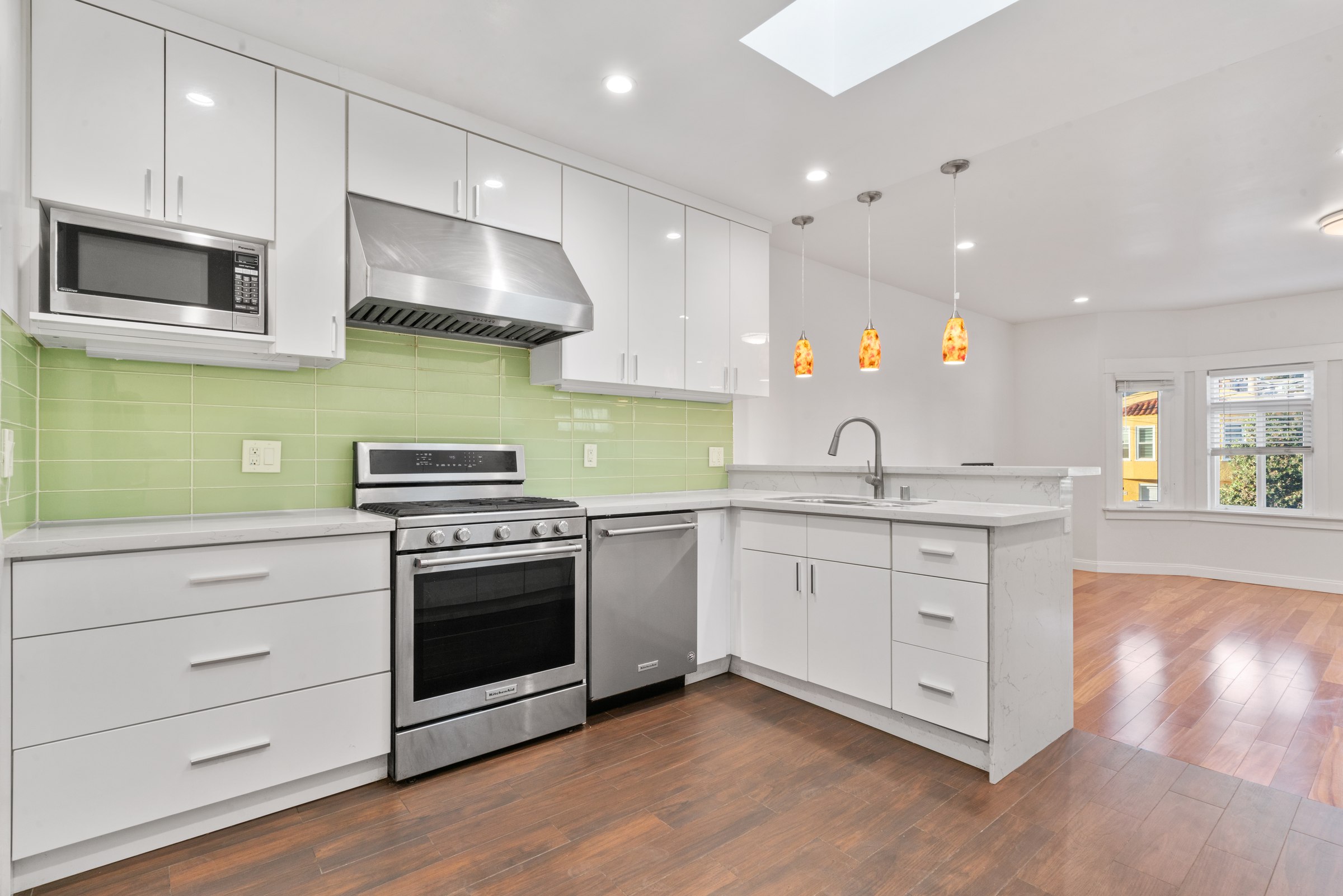 Upper kitchen with stainless steel range and white cabinetry