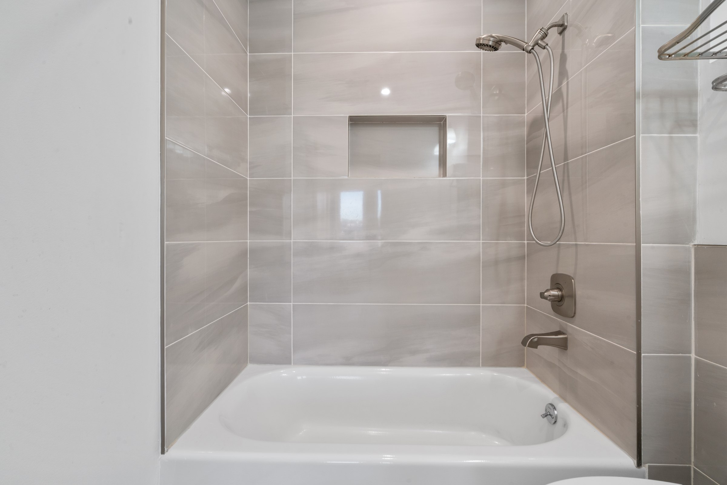 Upper residence bathroom with tiled bathing area