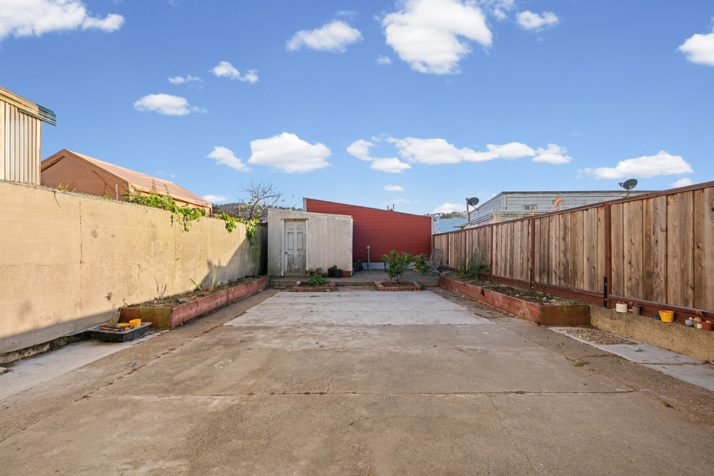 Paved backyard and rear of the property